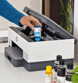 HP Smart Tank 580 ink filling process with color-coded bottles being inserted into matching ink tanks